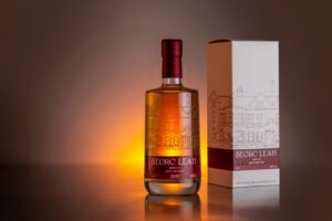 Photo of Beorc Leah Brandy bottle and box backlit with orange light