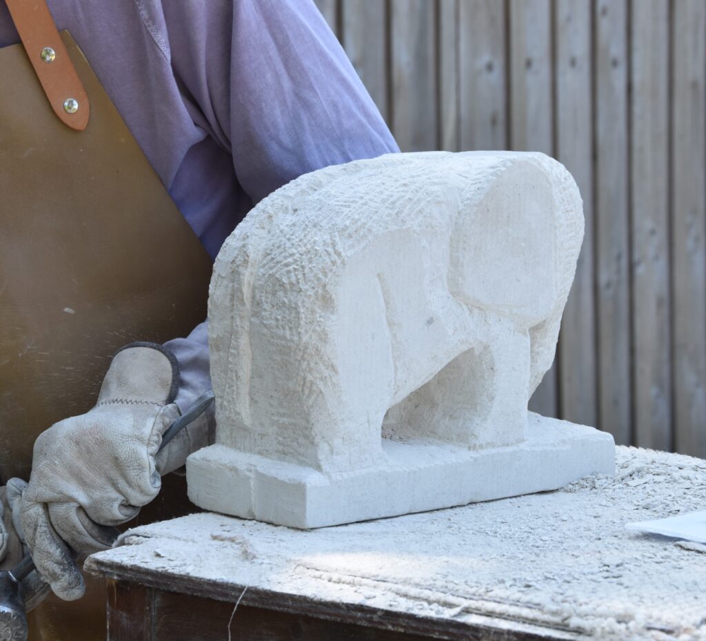 Hands only image of student carving and elephant, stone carving workshop with Simon Keeley at Birtley Estate